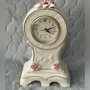 White ceramic mantel shelf clock. 6 3/8 inches wide.